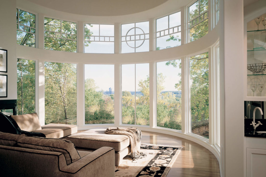 A White Bow style Window in a living room featuring lots of natural light in an open concept space